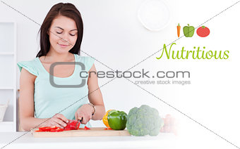 Nutritious against cute woman slicing a pepper