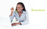 Micronutrients against businesswoman working with a laptop while eating a salad