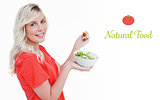 Natural food against side view of a young woman showing a great smile while eating salad