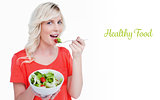 Healthy food against vegetable salad eaten by a smiling fairhaired woman
