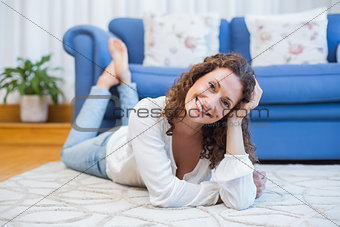 Smiling woman lying on the floor