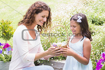 Happy mother and daughter collecting easter eggs