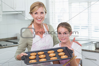 Mother and daughter making cookies together