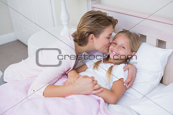 Mother with her daughter at bedtime