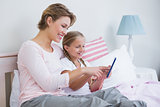 Mother and daughter using tablet pc