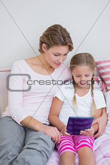 Mother and daughter using tablet pc