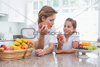 Mother and daughter holding apples