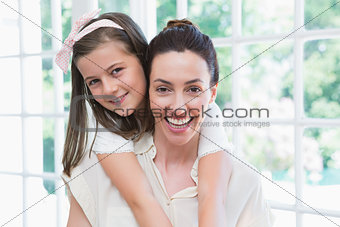 Mother and daughter smiling at camera