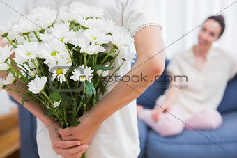 Daughter giving mother white bouquet