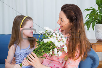 Daughter surprising mother with flowers