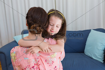 Little girl with her mother on sofa