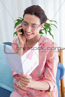 Mother reading a lovely card on phone call