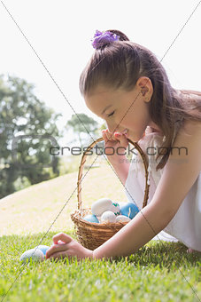 Little girl collecting easter eggs
