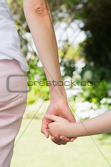 Mother and daughter holding hands