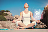 Composite image of blonde woman sitting in lotus pose on beach on mat
