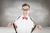 Composite image of geeky hipster pulling his suspenders