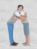 Composite image of geeky hipster couple hugging