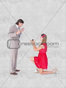 Composite image of pretty hipster on bended knee doing a marriage proposal to her boyfriend
