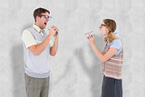 Composite image of geeky hipster couple speaking with tin can phone