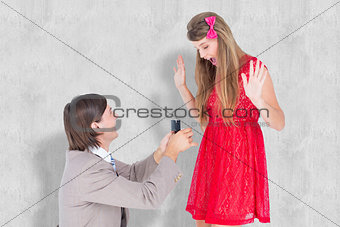 Composite image of hipster on bended knee doing a marriage proposal to his girlfriend