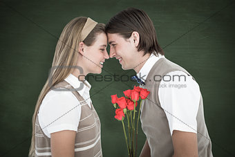 Composite image of happy geeky hipsters looking at each other