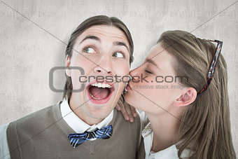 Composite image of pretty geeky hipster giving boyfriend kiss on the cheek