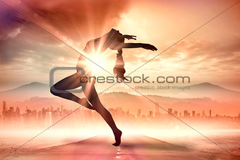 Composite image of side view of a sporty young woman stretching
