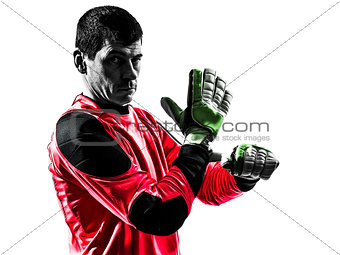 caucasian soccer player goalkeeper man adjusting gloves silhouet