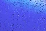 Blue water drops on the glass