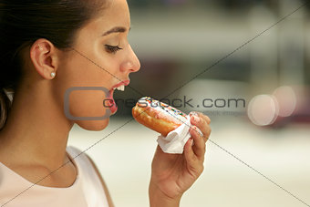 Business Woman Eating Delicious Donut In Street