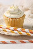 Closeup of vanilla cupcake with straws