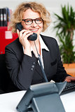 Front desk lady attending clients call