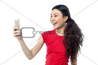 Amused girl clicking a selfie