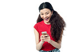 Excited pretty girl sending a text message