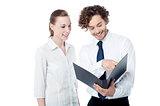 Businessman and woman looking at folder