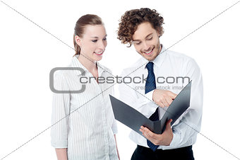 Businessman and woman looking at folder