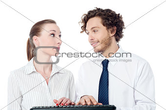 Young secretaries typing in keyboard