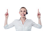 Young call center woman pointing up