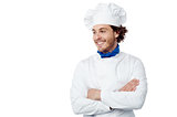 Smiling young male chef posing confidently