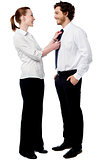 Pretty woman adjusting her husband's tie