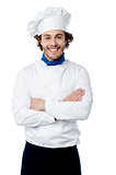 Confident young chef posing in uniform