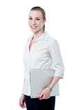 Happy business executive holding laptop