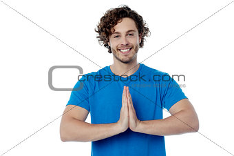 Smiling young man in welcome gesture