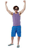 Excited young man raising his arm