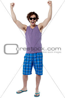 Excited young man raising his arm