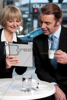 Cheerful business people using digital tablet