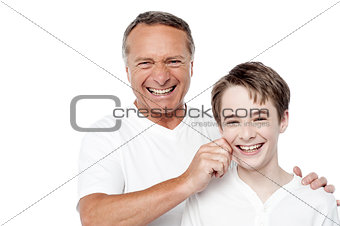 Father and son playing, pinching cheeks