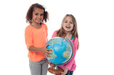 Little girls playing with globe