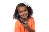 Little girl speaking over phone