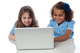 Cute little school girls with laptop